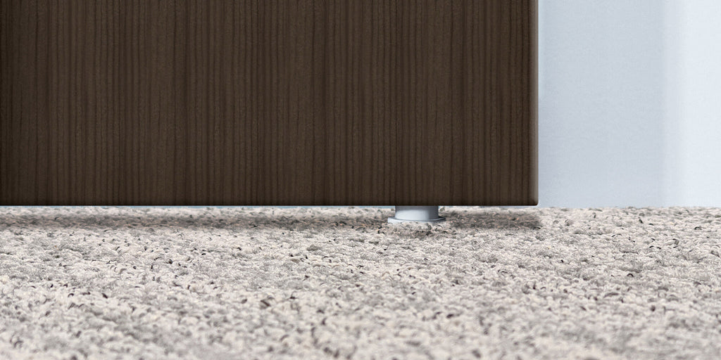 Close-up of floor area beneath sliding glass door showing no bottom track or sliding elements