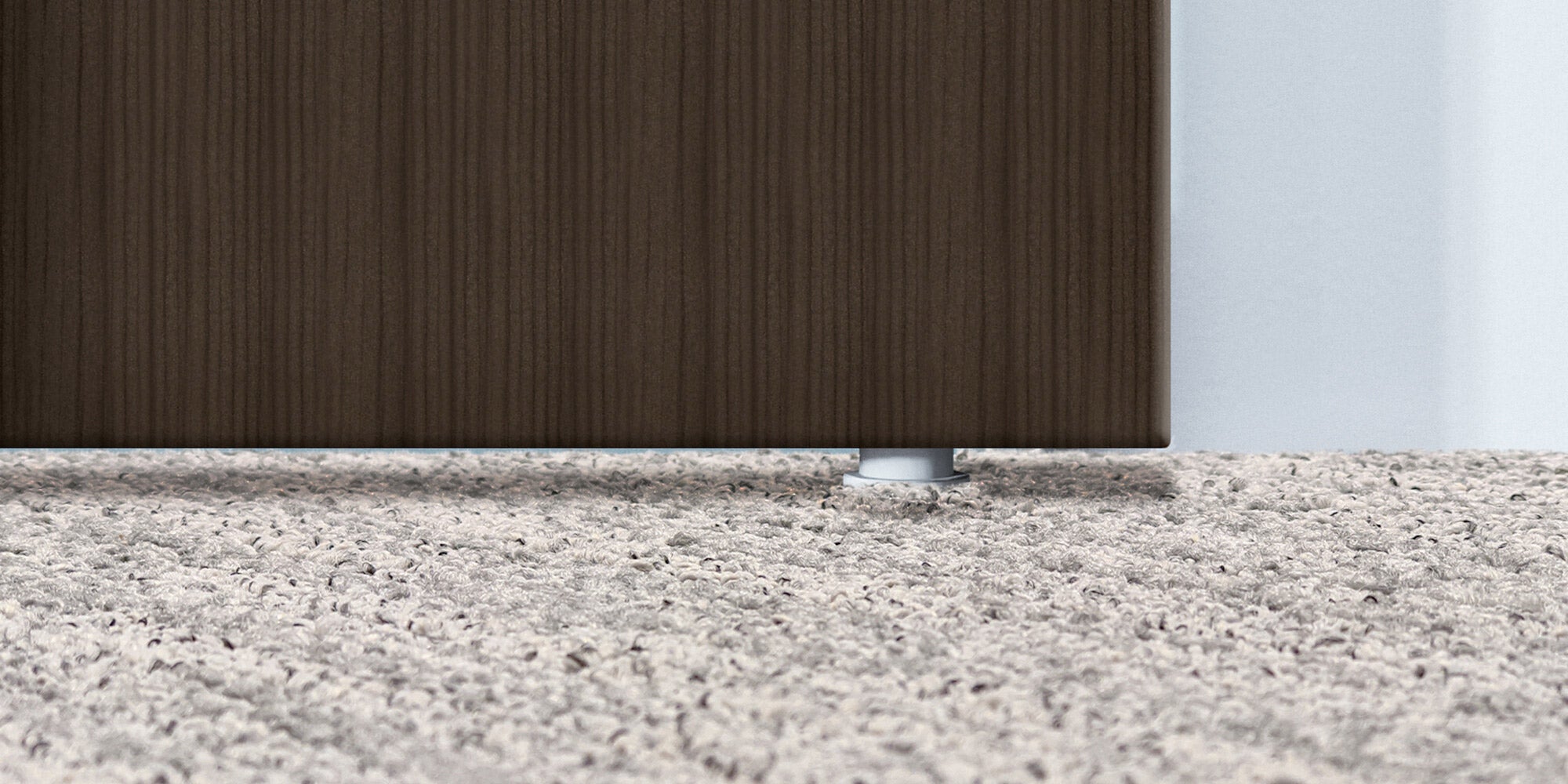 Close-up of floor area beneath sliding glass door showing no bottom track or sliding elements