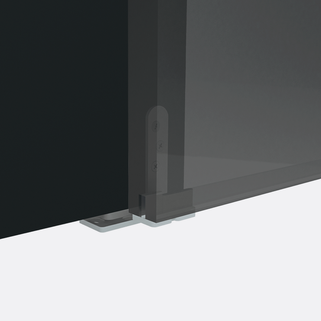 Corner of a black flat-screen TV on a white surface with a dark background