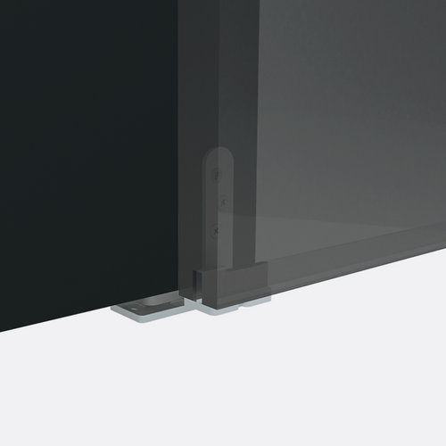 Corner of a black flat-screen TV on a white surface with a dark background