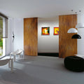 Modern interior with wooden sliding doors, abstract art, and minimal furniture.