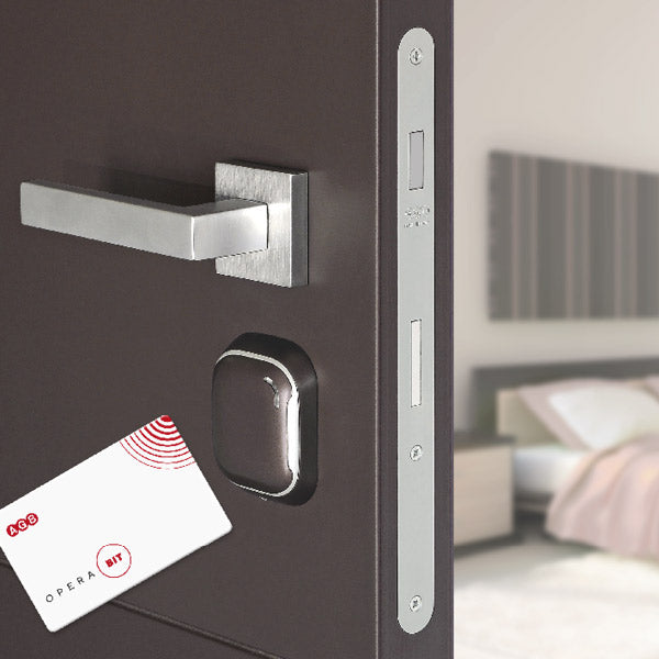 Key card against the Opera Bit reader installed on a brown door