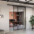 Modern office interior with glass partition walls and office furniture.