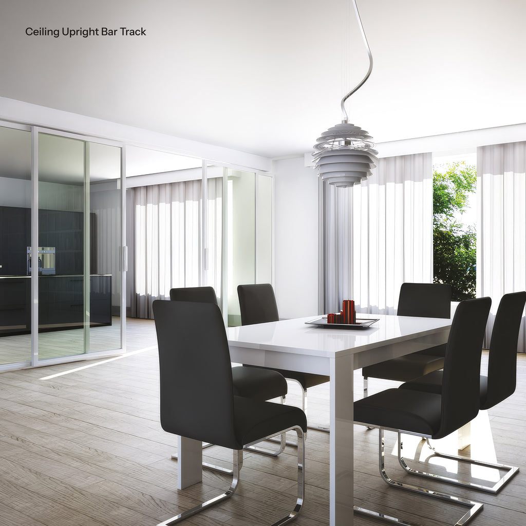 Modern dining room with a white table and black chairs, featuring a ceiling upright bar track.