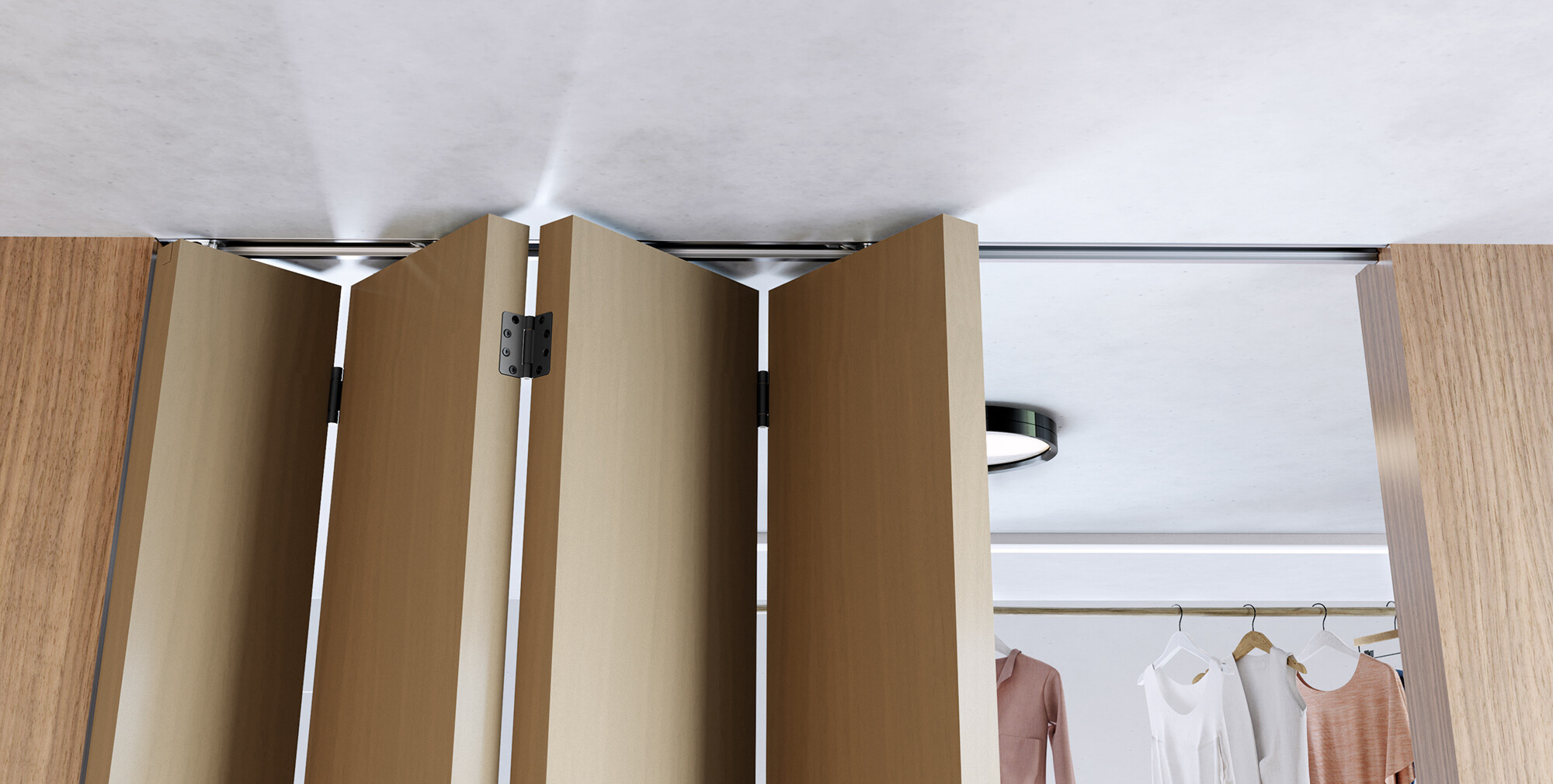 Ceiling-mounted folding partition with wooden finish in a room with clothing racks.
