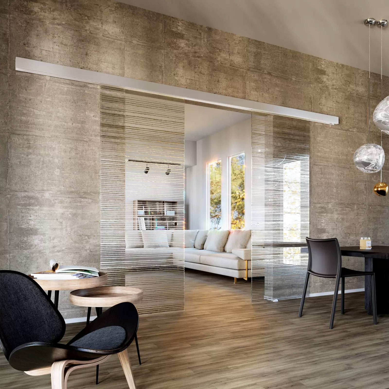 Modern living room with glass walls, furniture, and decor.