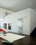Modern interior with a glass door, staircase, and decorative items.