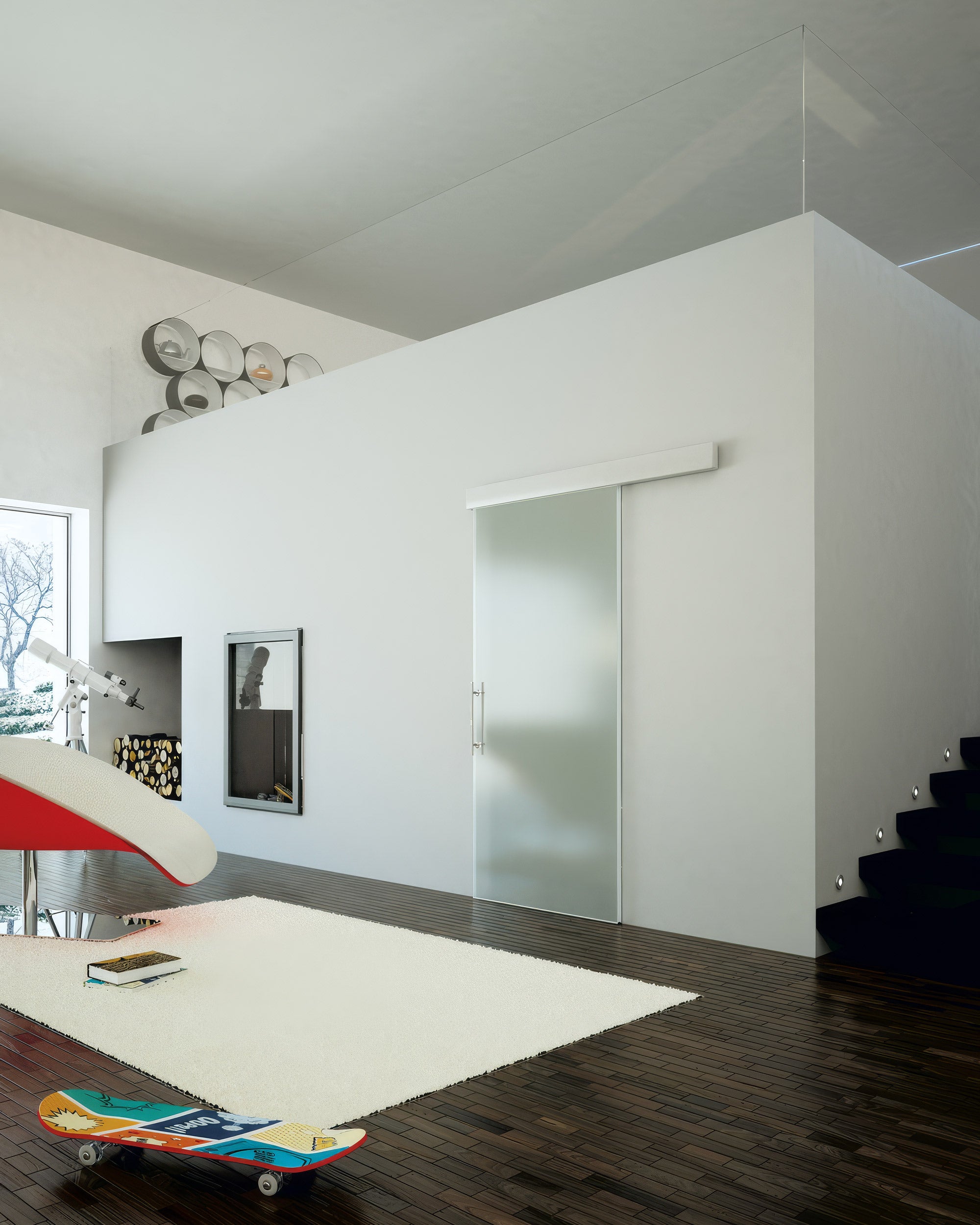 Modern interior with a glass door, staircase, and decorative items.