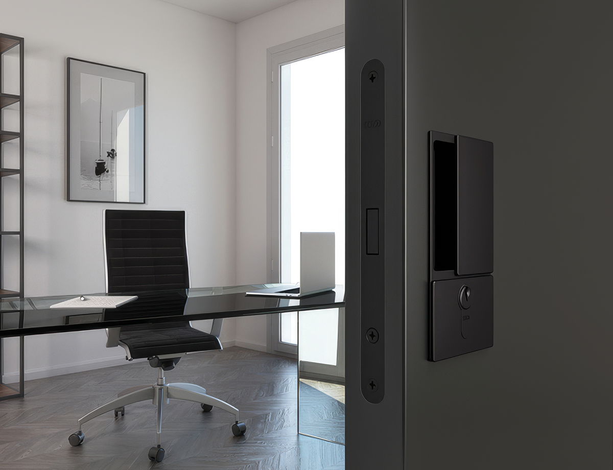 Modern office with a desk, chair, and wall-mounted device.