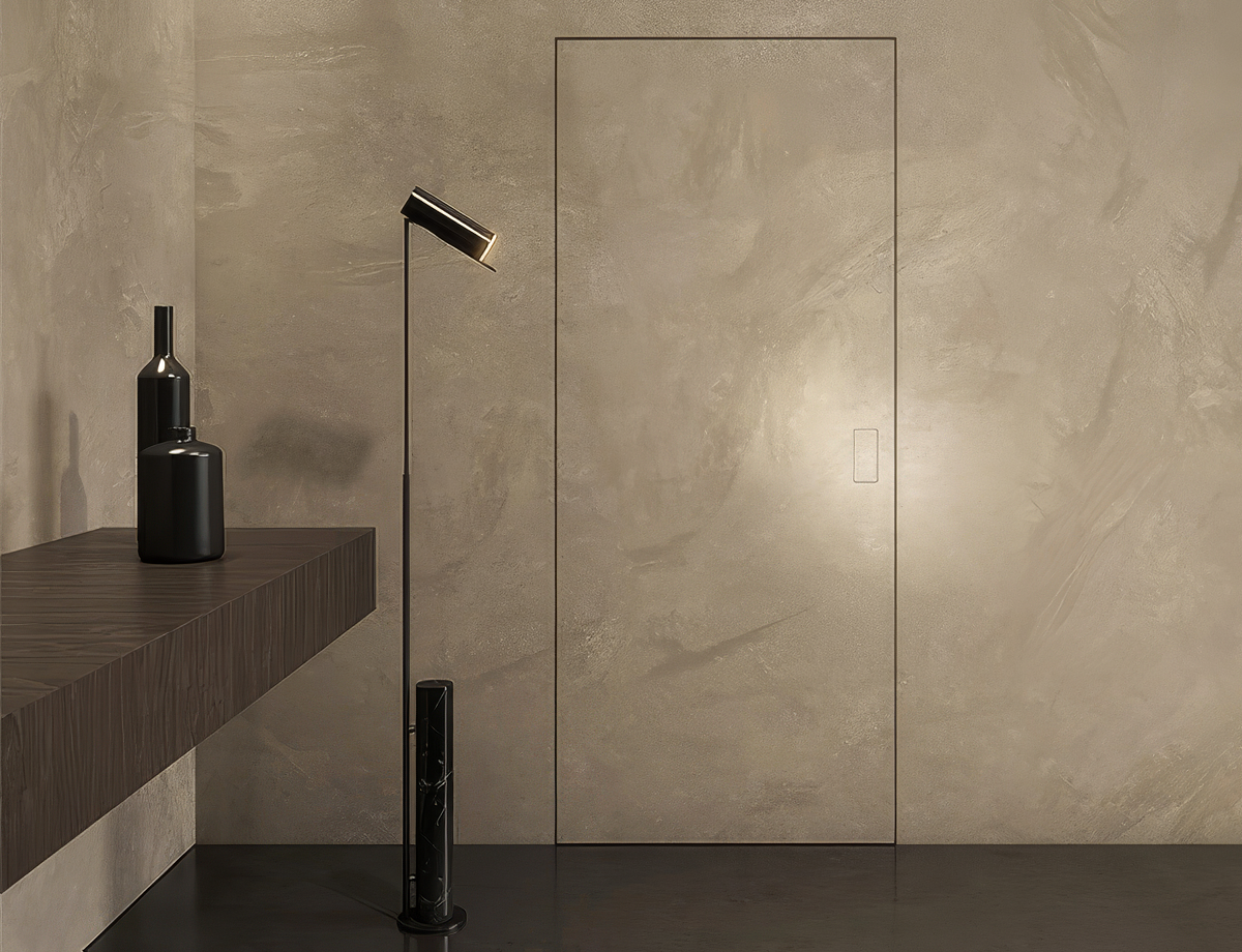 Modern floor lamp on a wooden side table against a textured wall.